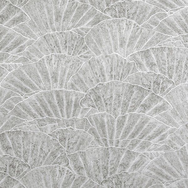 a close up of a gray tile with a fan pattern on it .