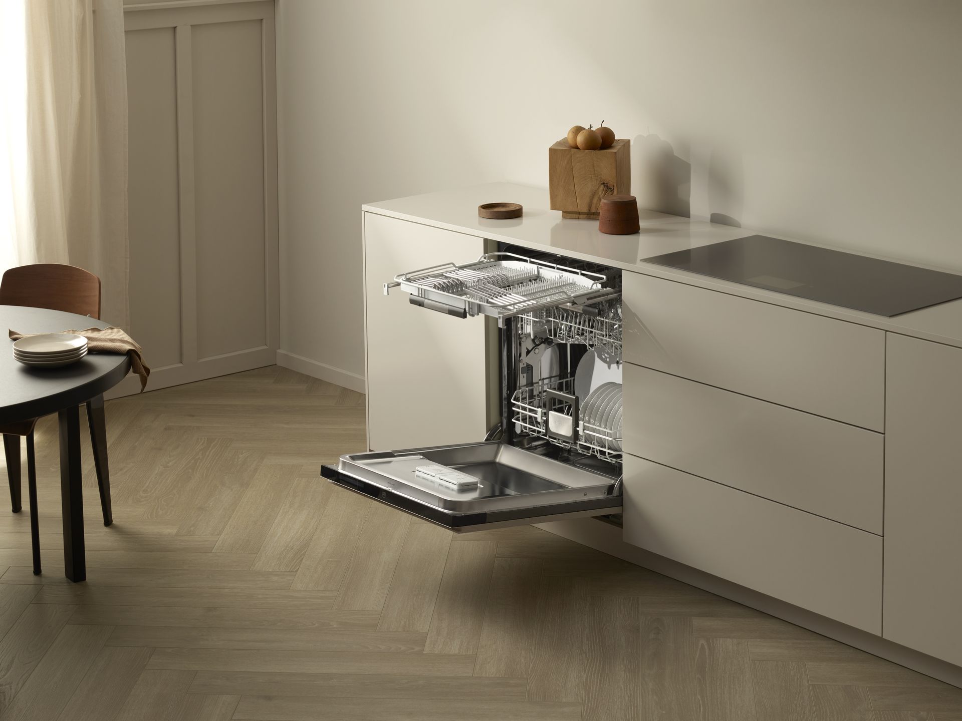 V-ZUG dishwasher unit door open and internal shelf extended outwards ready for loading in luxury kitchen