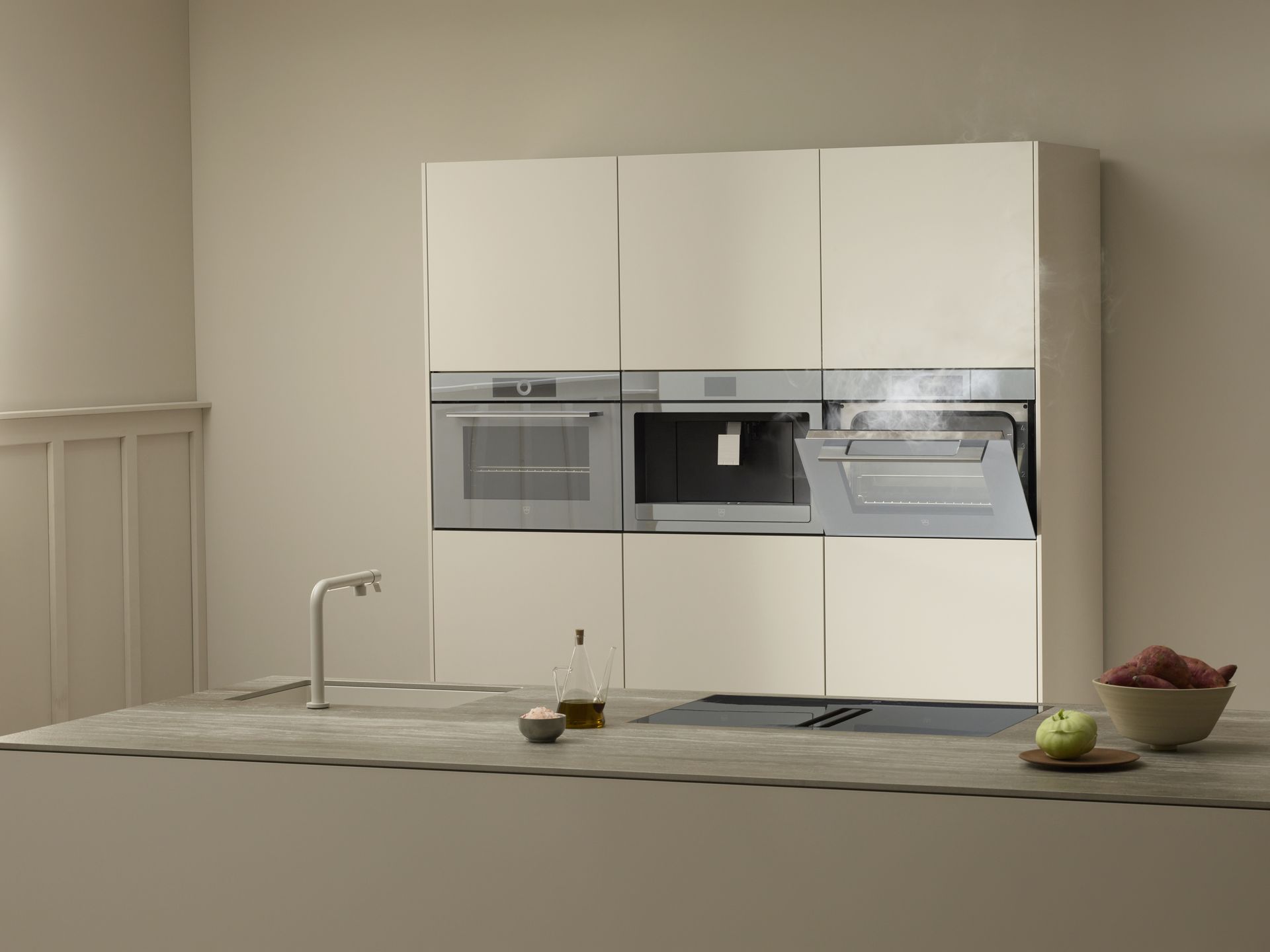 V-ZUG triple cooker, coffee machine and steamer with open door in luxury kitchen