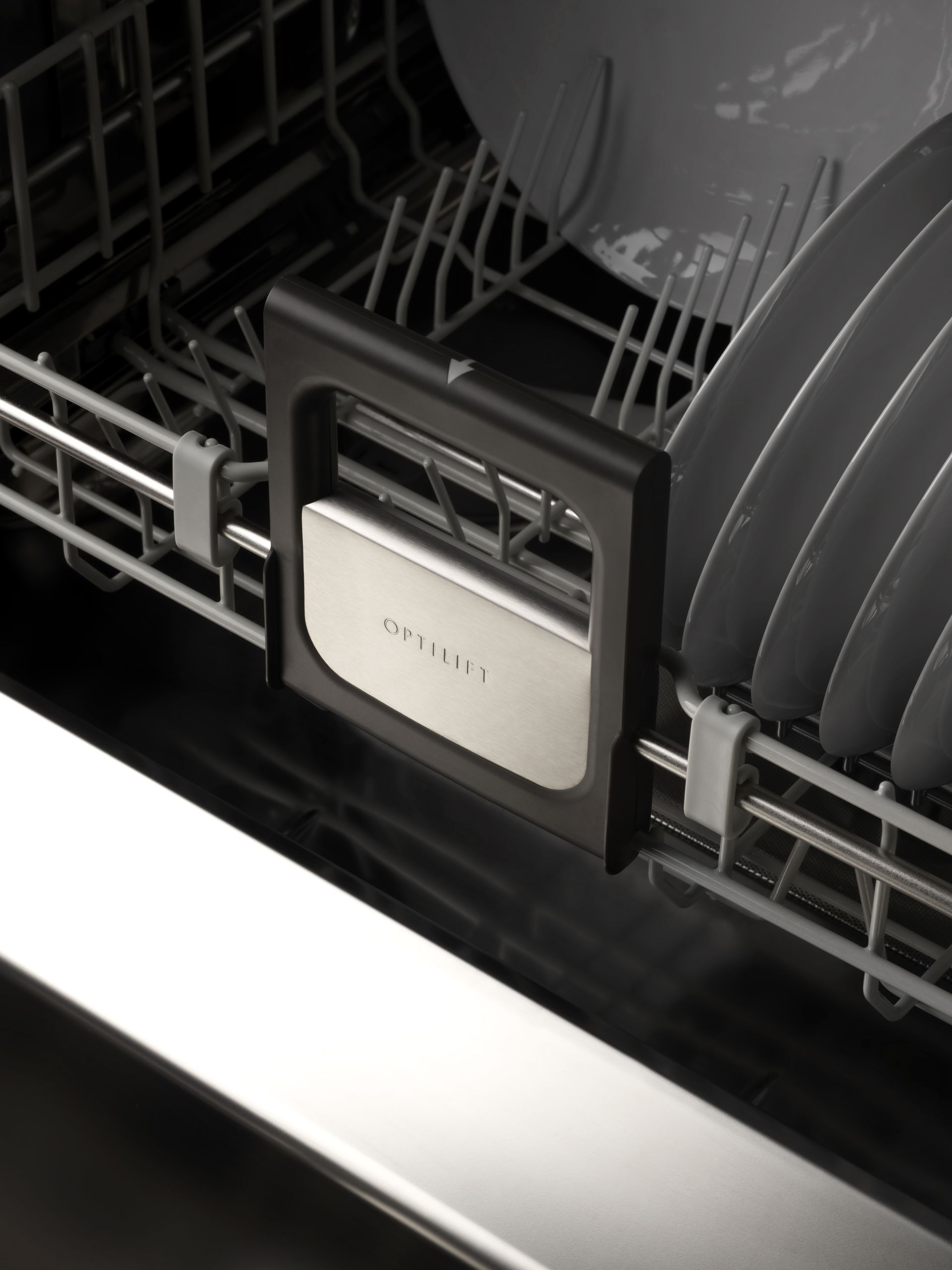 V-ZUG Adora V600 dishwasher unit door ajar in luxury kitchen showing internal drawers loaded with dishes