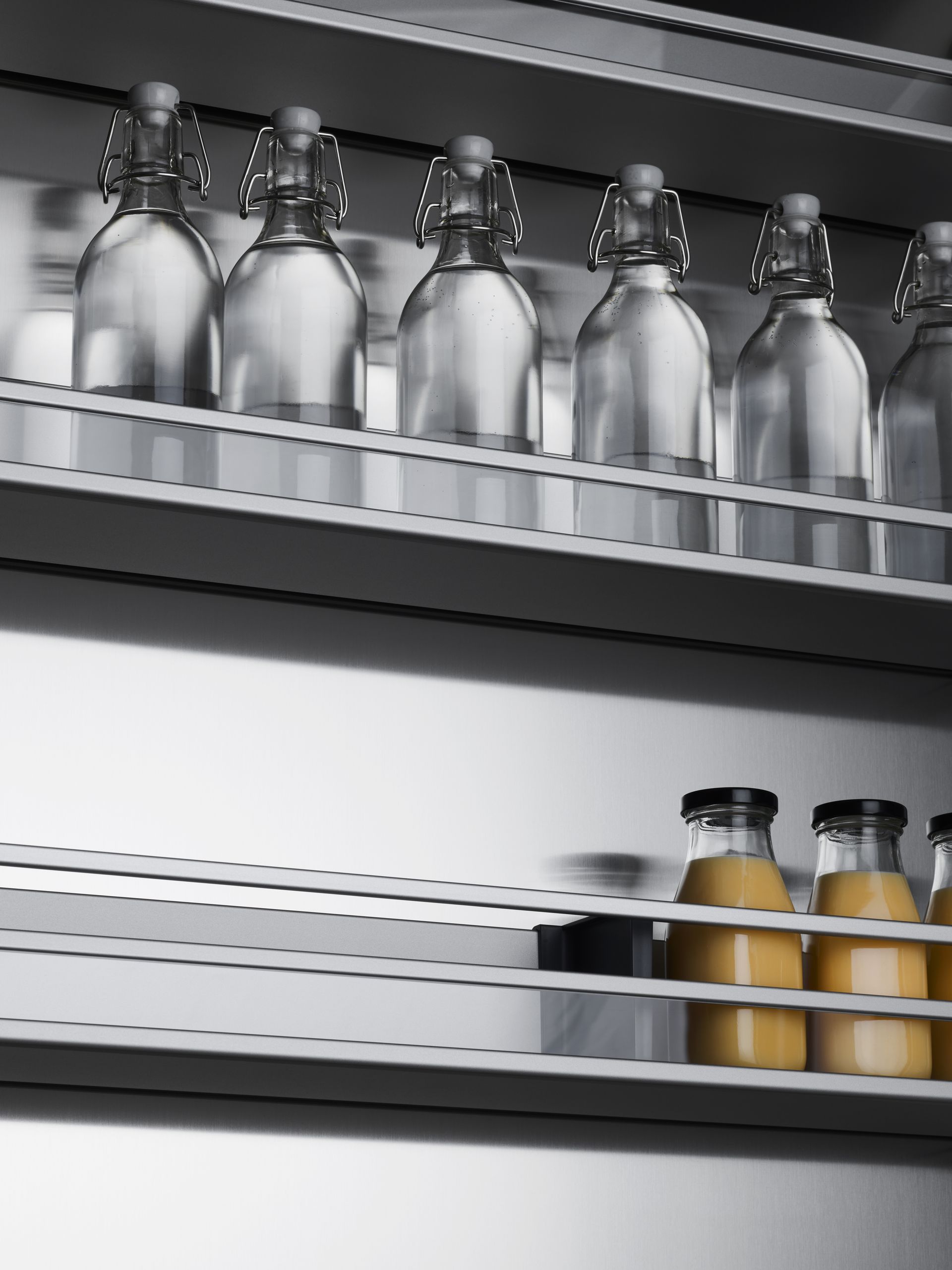 V-ZUG luxury kitchen with open fridge door showing shelving and bottle storage