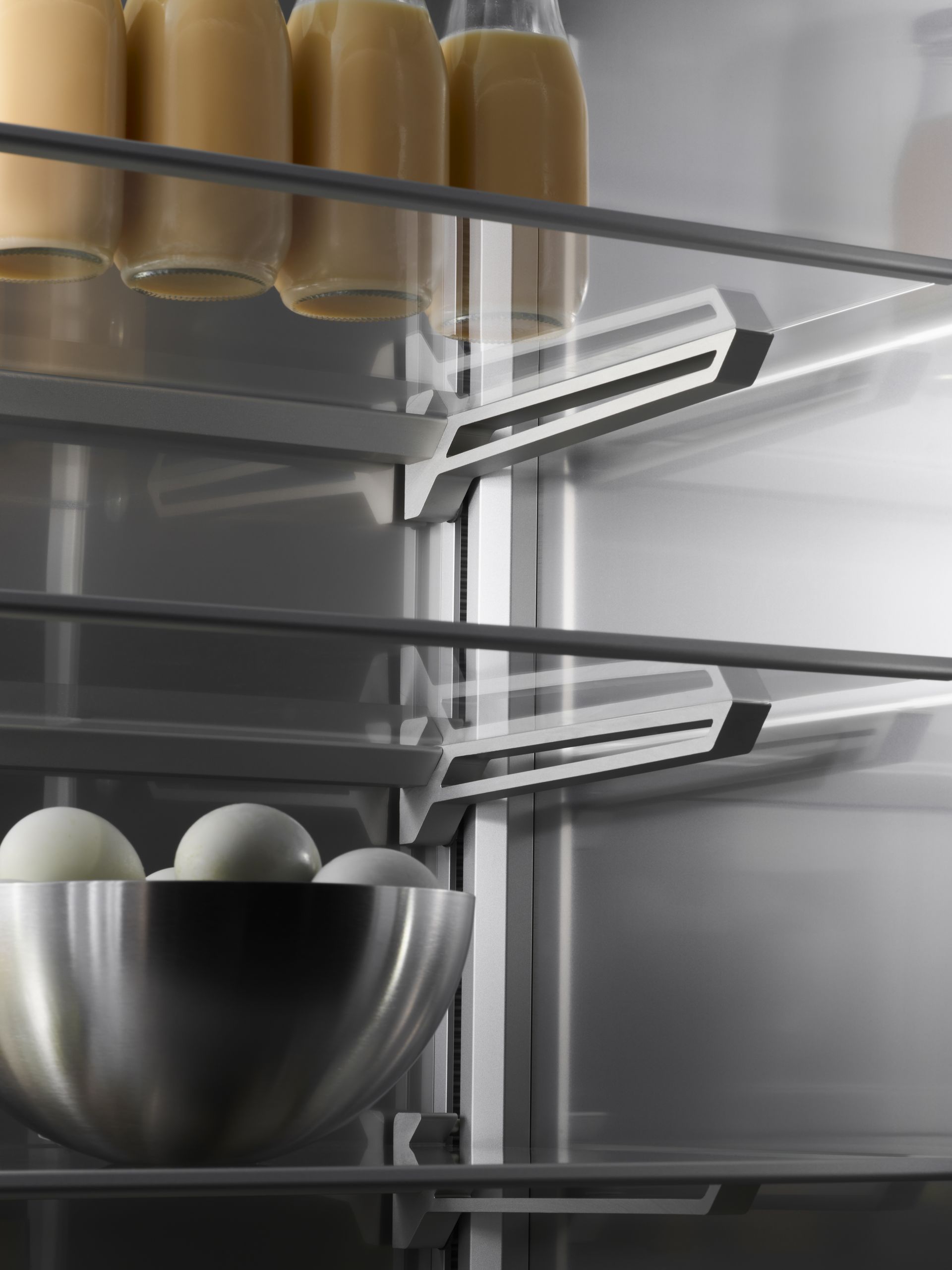 V-ZUG luxury kitchen with close up of open refriderator appliance showing shelving and food storage