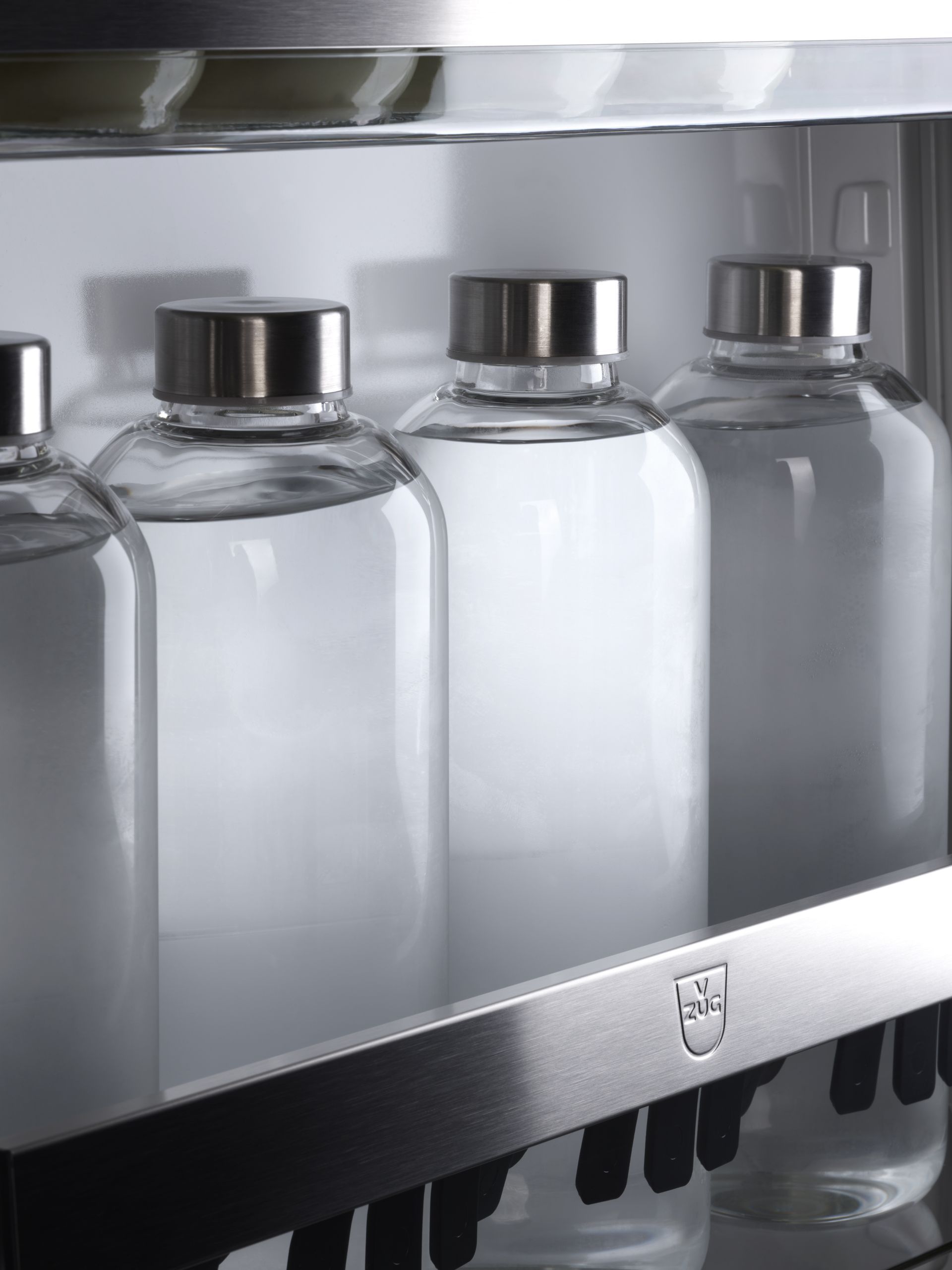 V-ZUG luxury kitchen with close up of open fridge door showing shelving and bottle storage