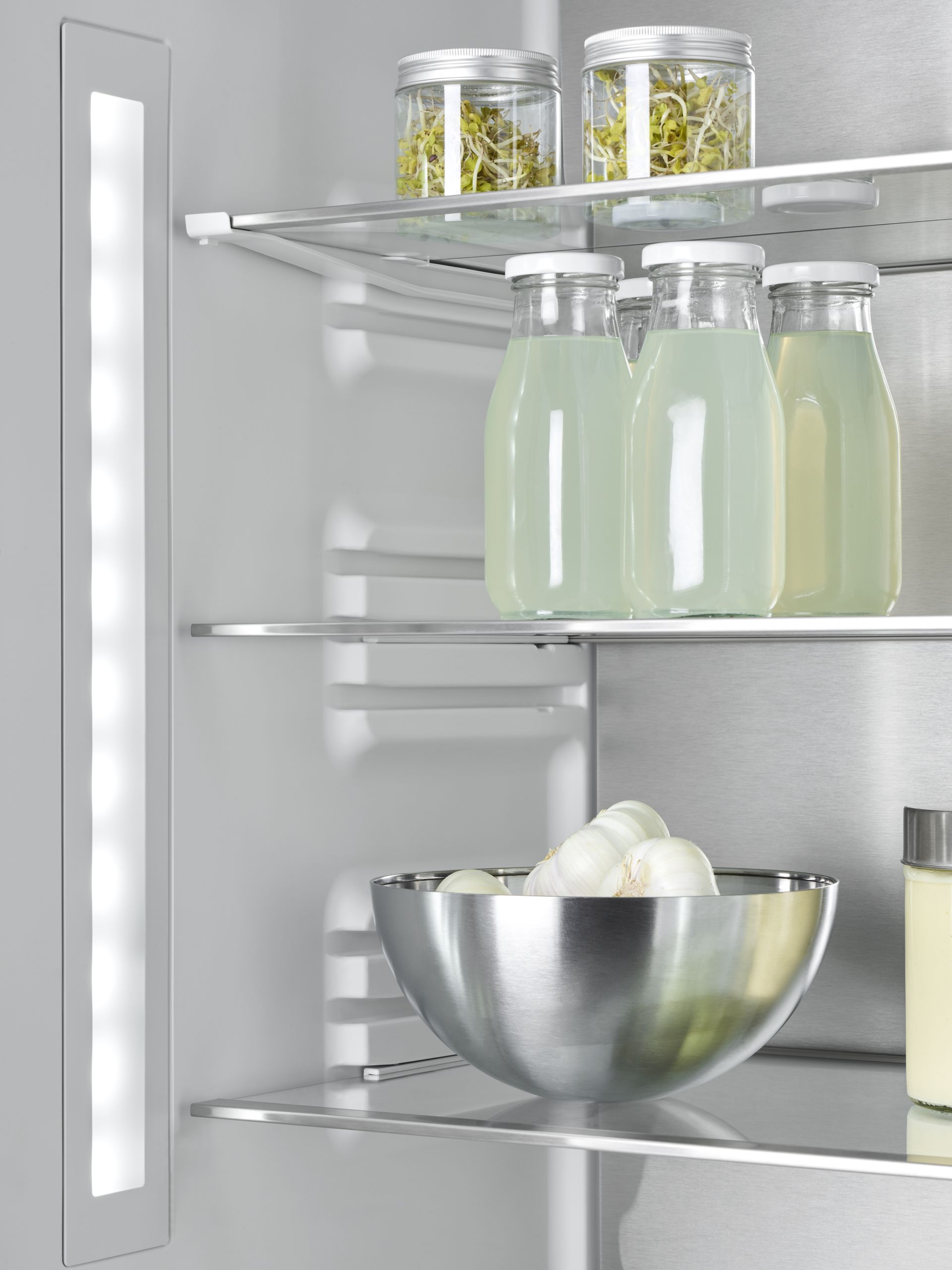 V-ZUG luxury kitchen with close up of v4000 combicooler open refriderator appliance showing shelving and food storage