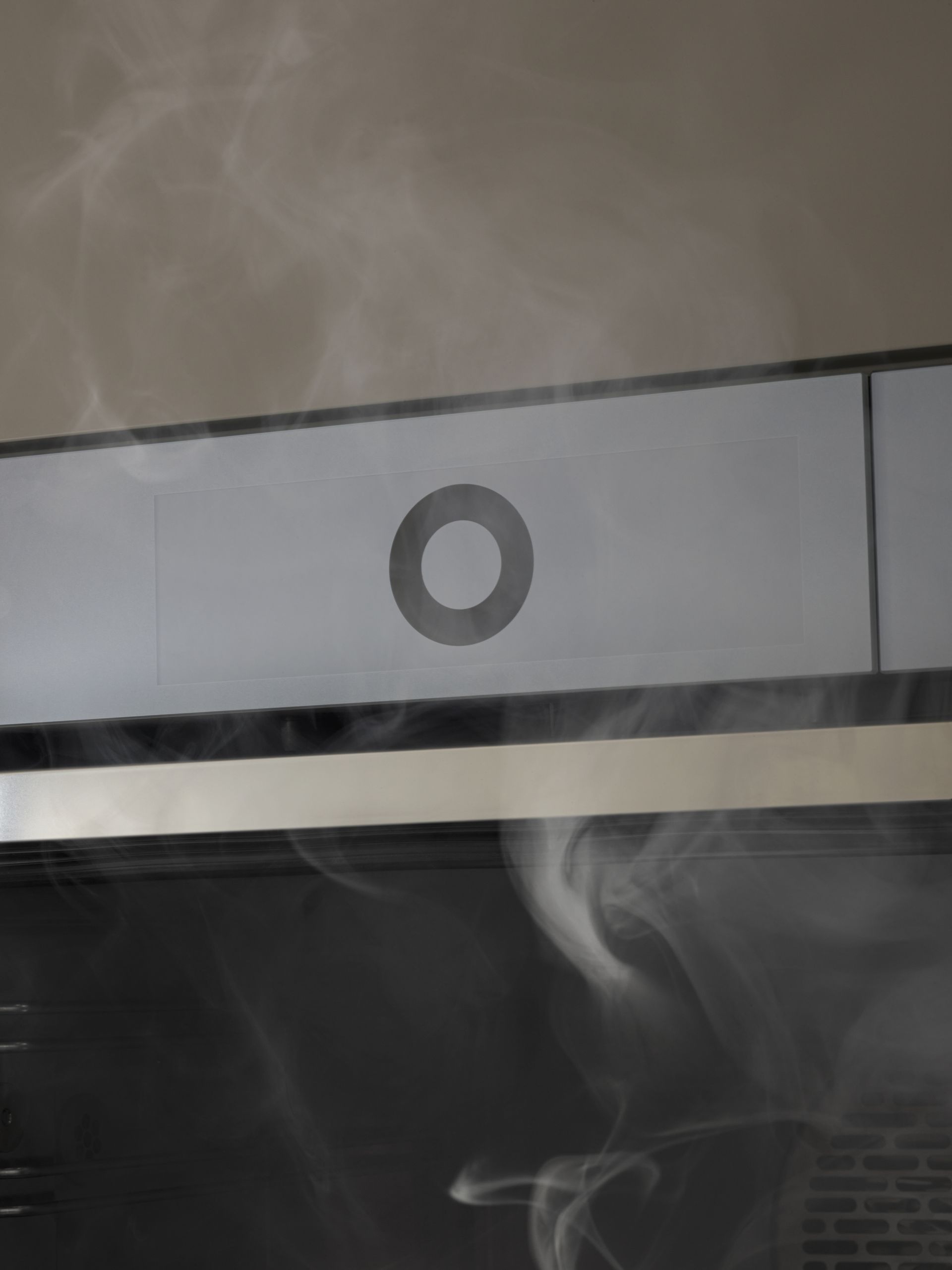 V-ZUG steamer in luxury kitchen with door ajar and steam rising