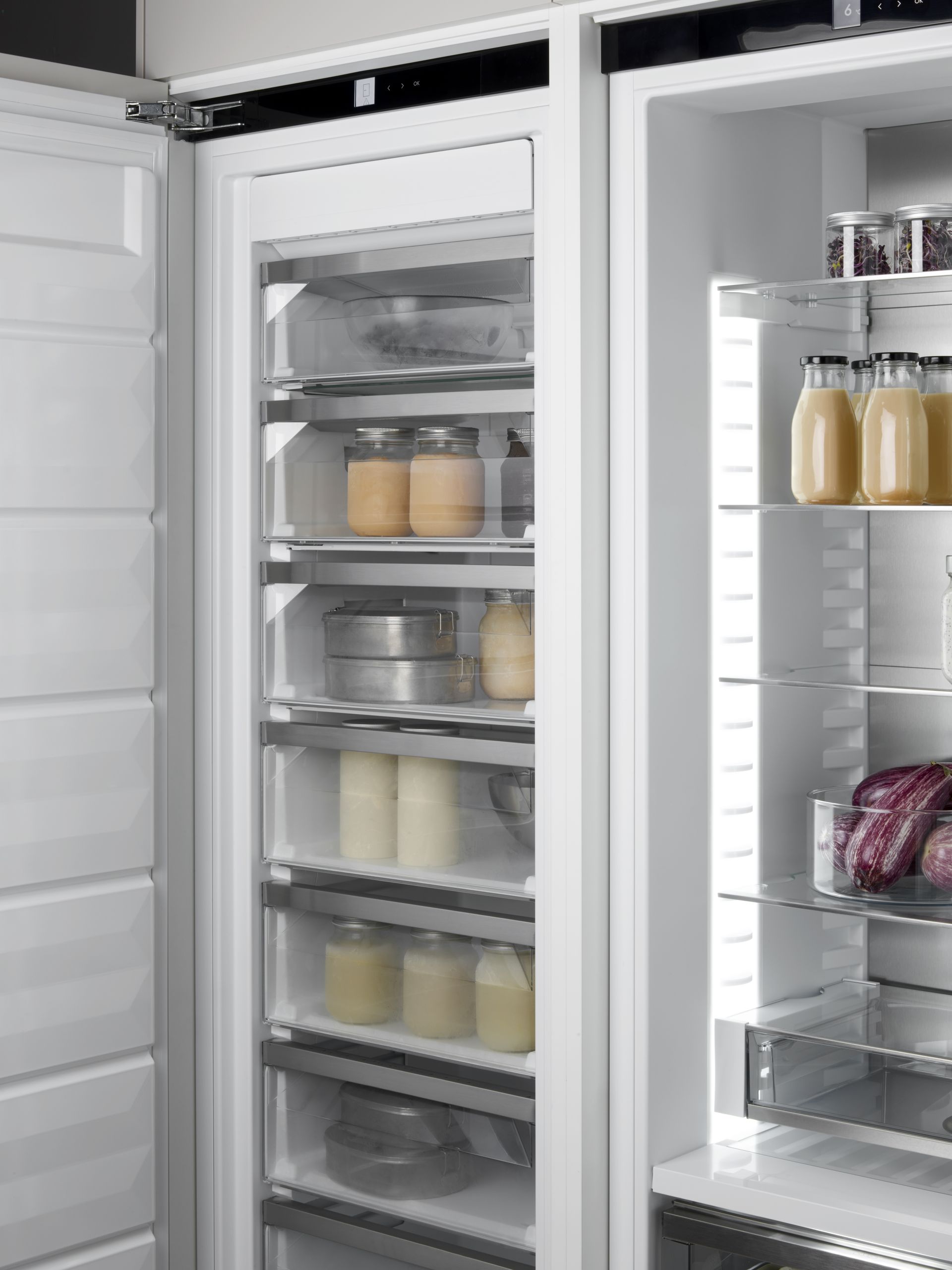 V-ZUG luxury kitchen with close up of open freezer appliance showing drawers and food storage