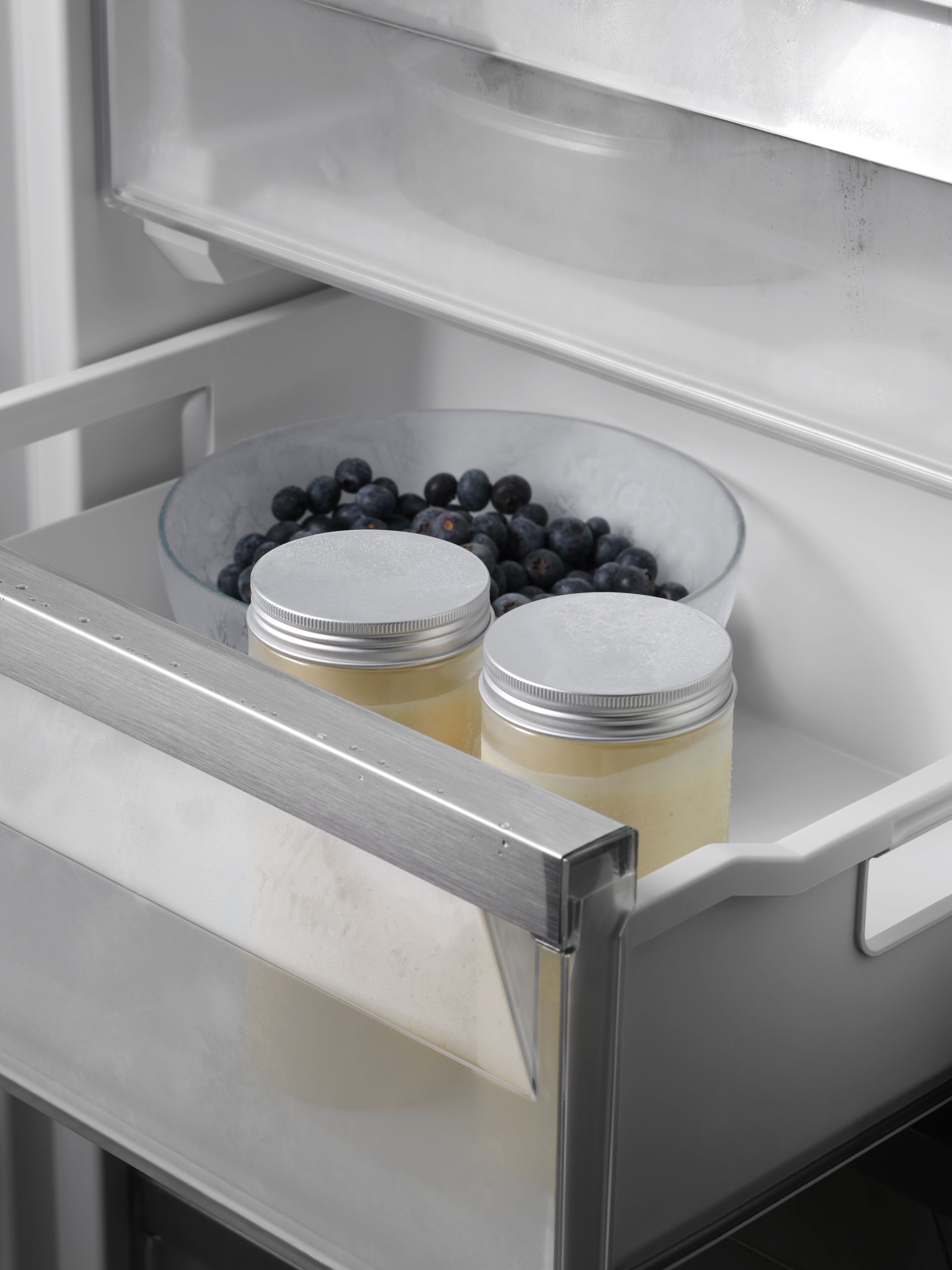 V-ZUG fridge internal drawer shot with fruit and jars in luxury kitchen