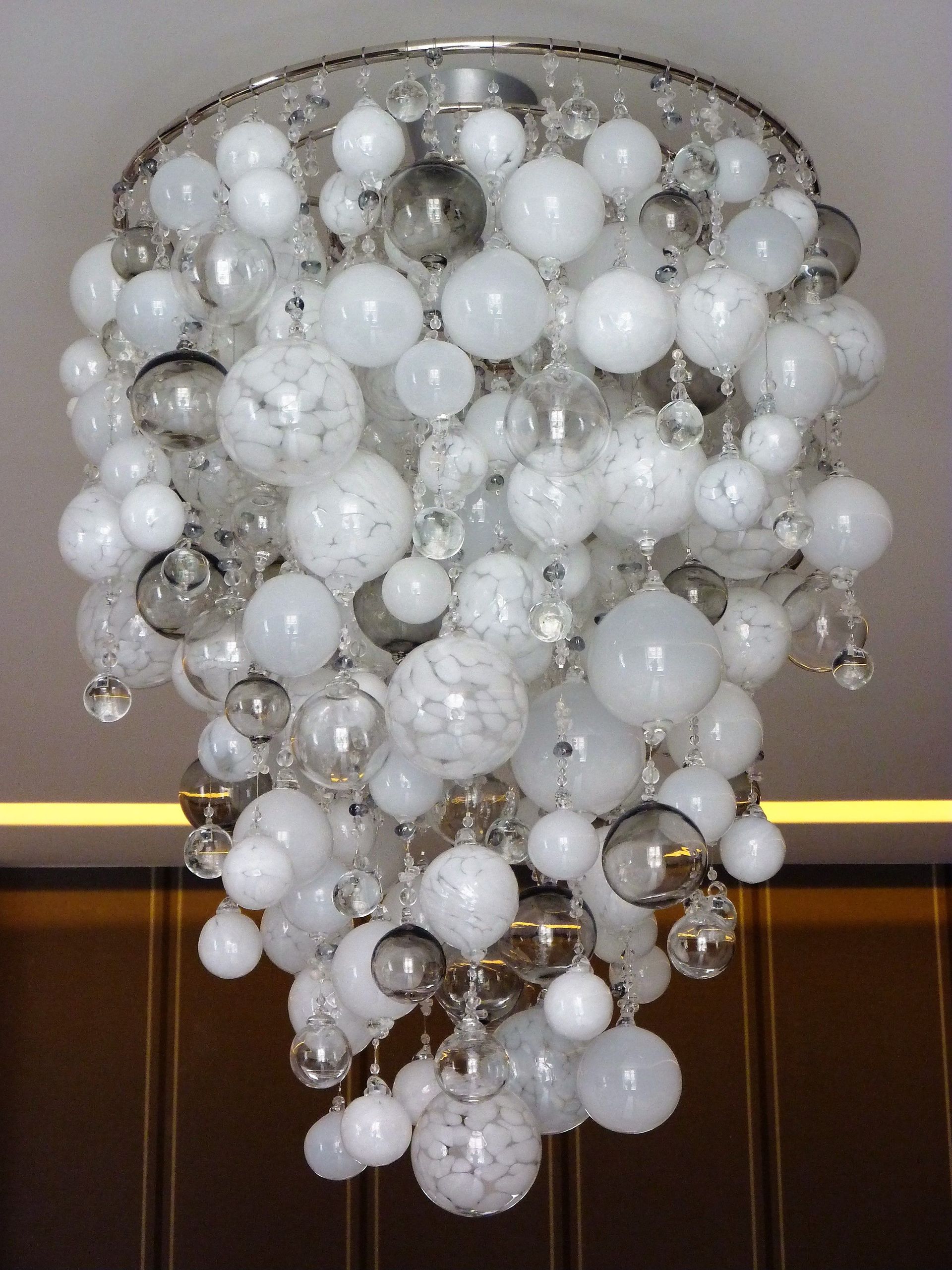 a Roast Designs white glass ball chandelier hanging from the ceiling
