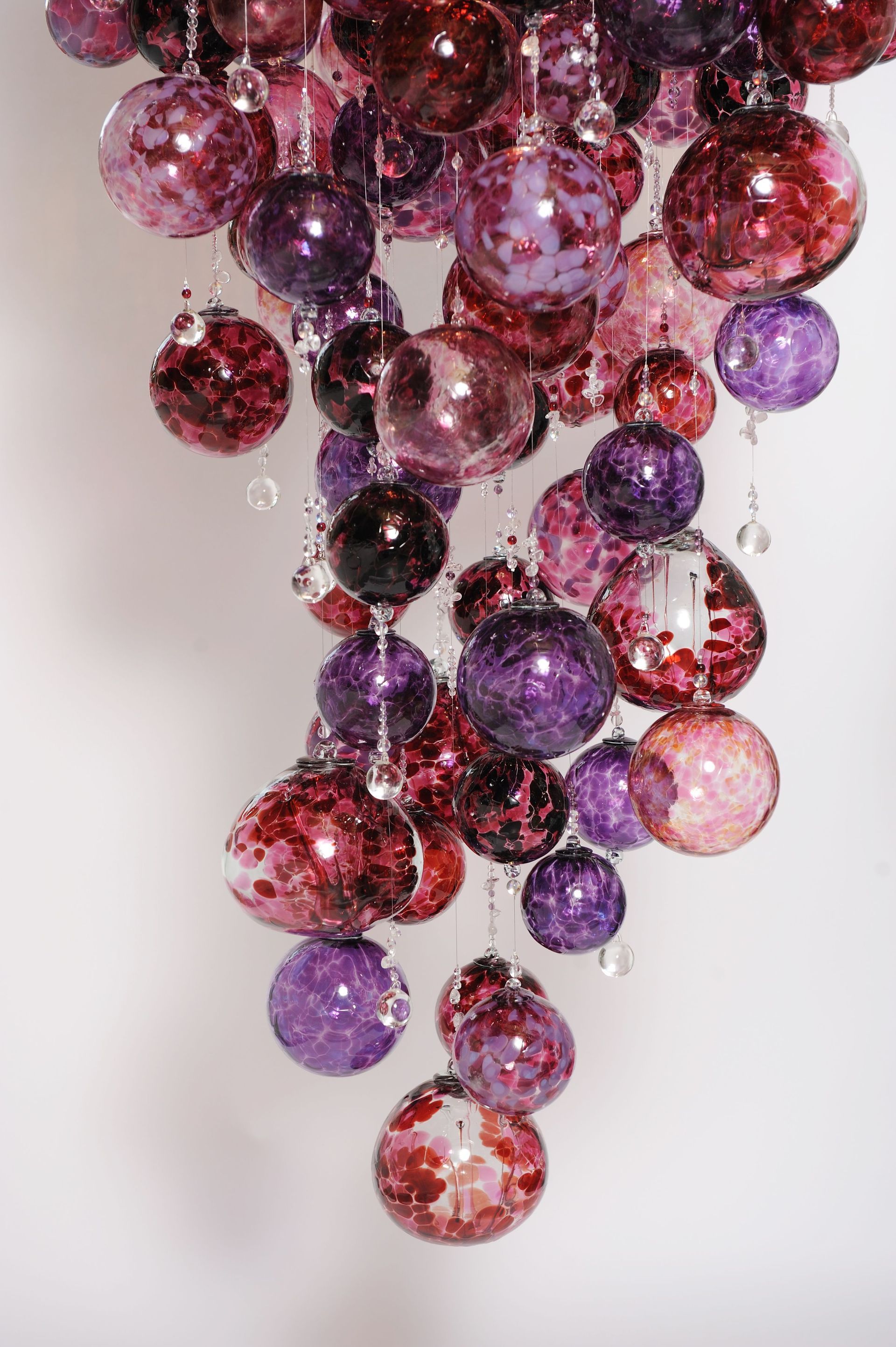 close up shot of a Roast Designs purple coloured glass balls  chandelier hanging from the ceiling