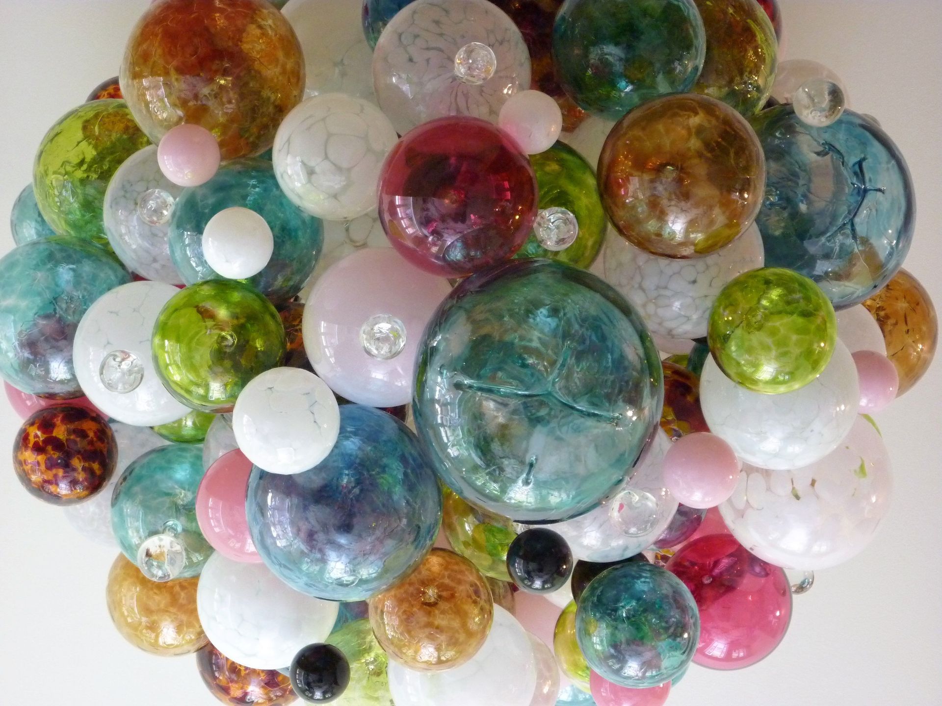 close up shot of a Roast Designs mixed coloured glass balls light hanging from the ceiling