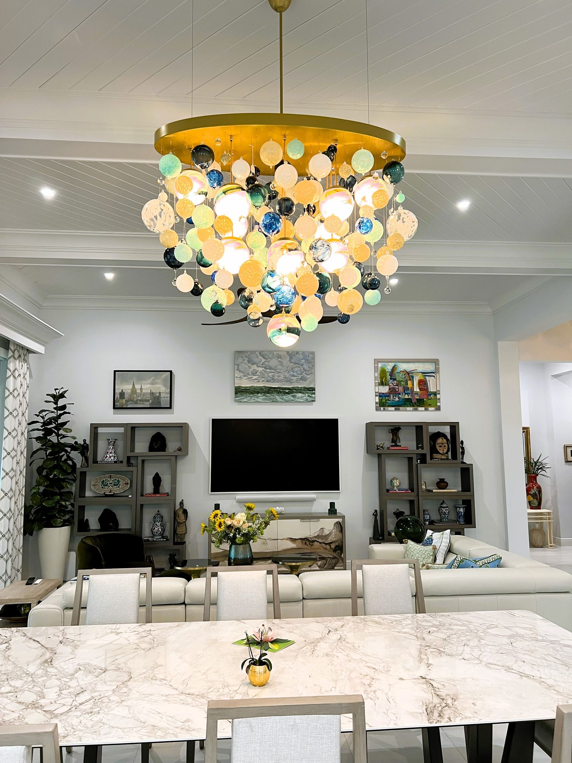 a Roast Designs mixed glass ball chandelier hanging from the ceiling in lounge