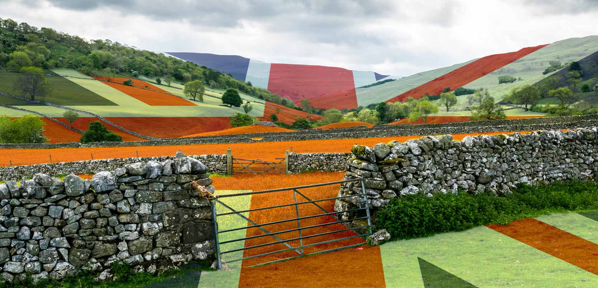 a stone wall surrounds a field with a british flag painted on it