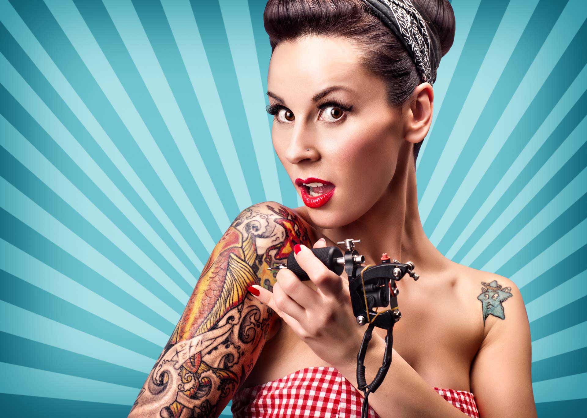 a woman with a tattoo on her arm is holding a tattoo machine