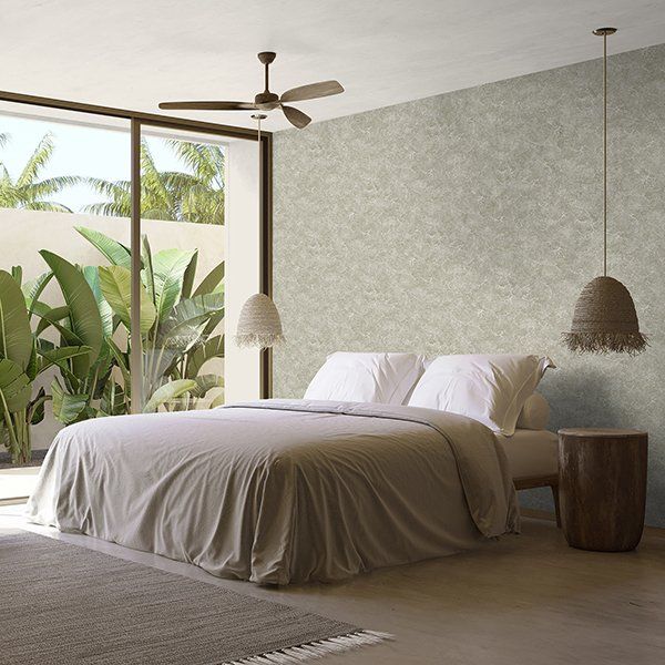 a bedroom with a large bed and a ceiling fan