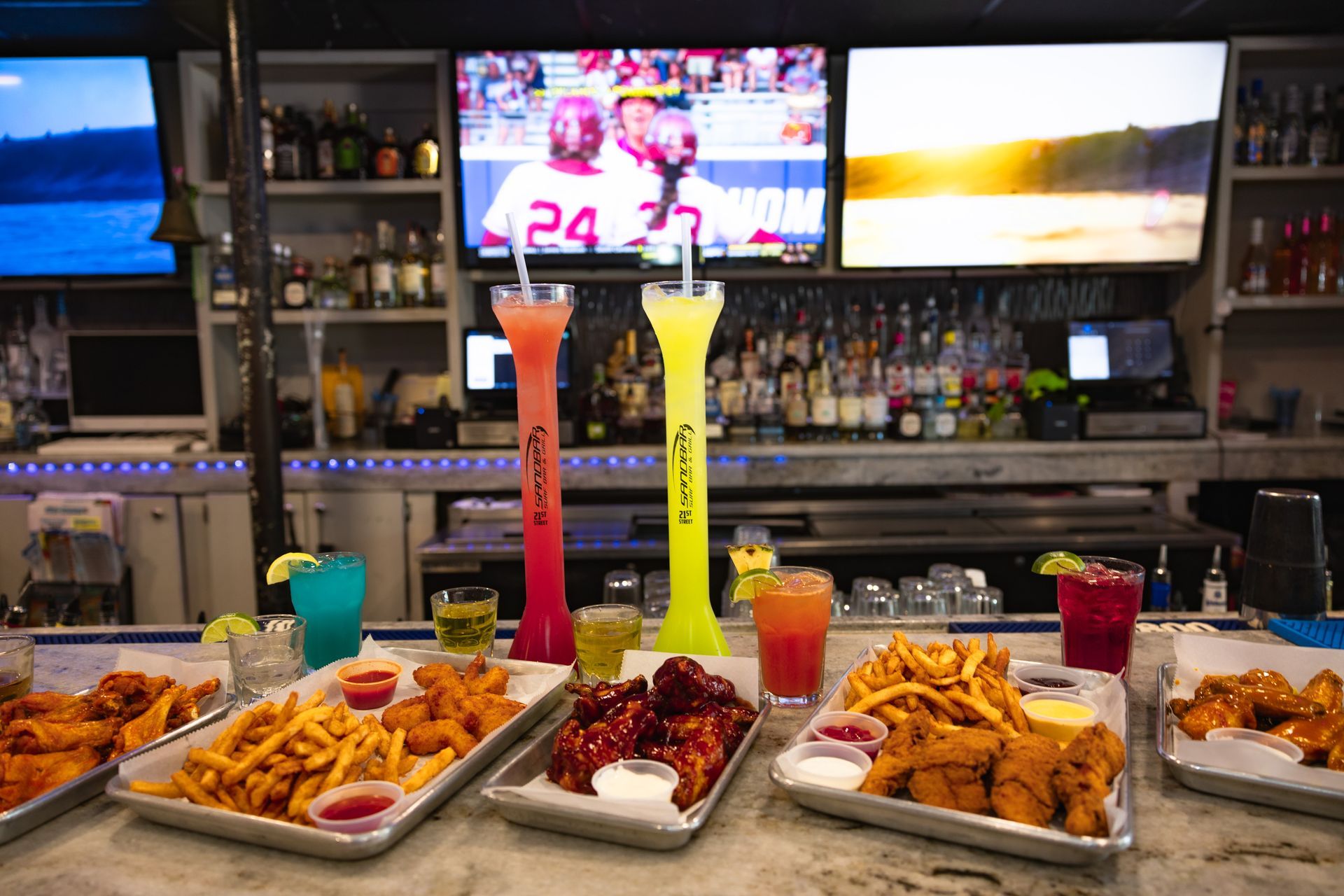 A bar with a lot of food and drinks on it.