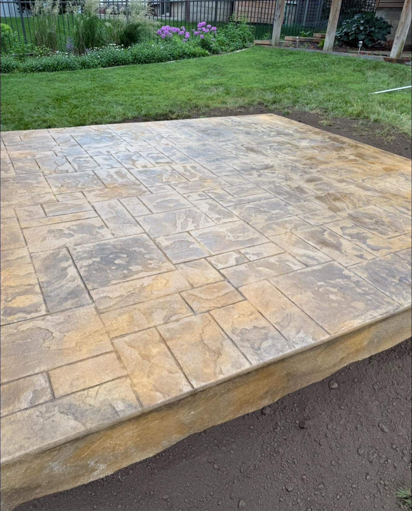 Multi-colored brick paving, alternating yellow, red, and gray rectangular bricks.