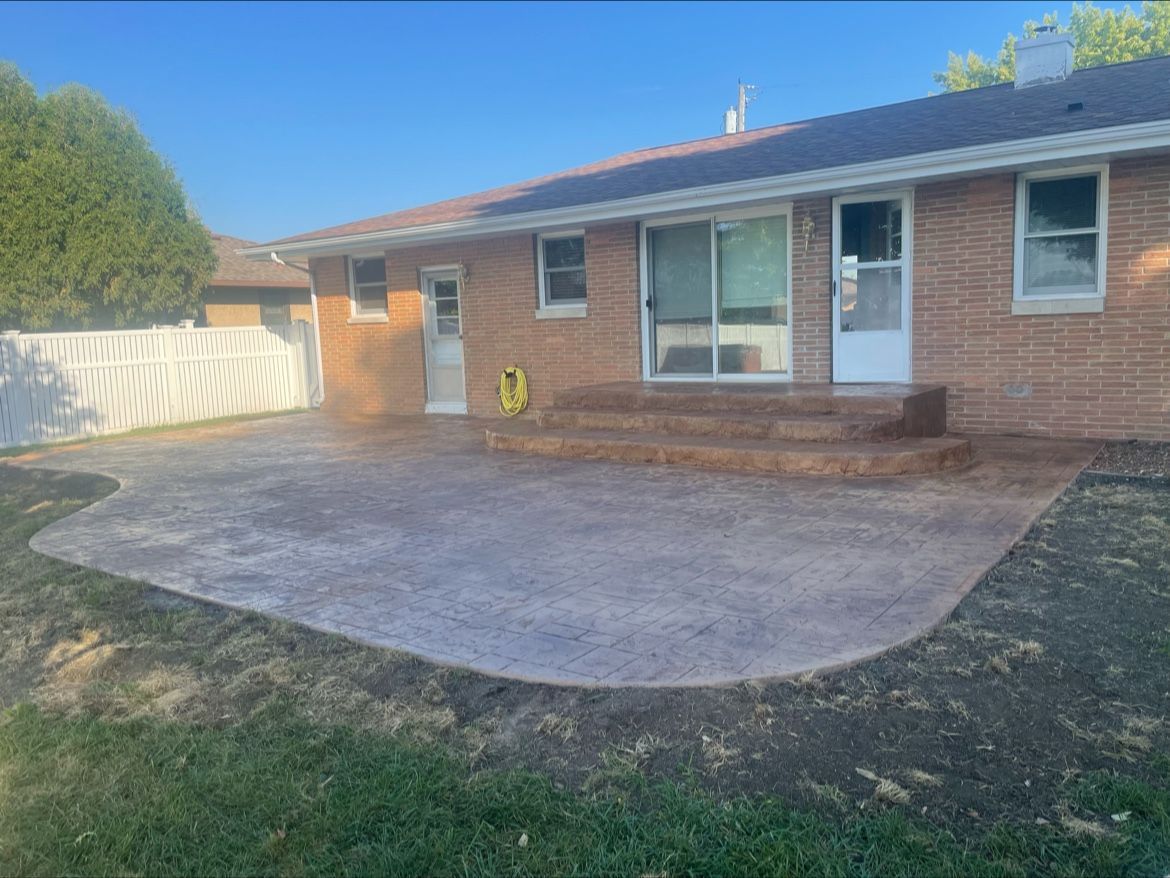 Cobblestone street covered in snow next to a curb.
