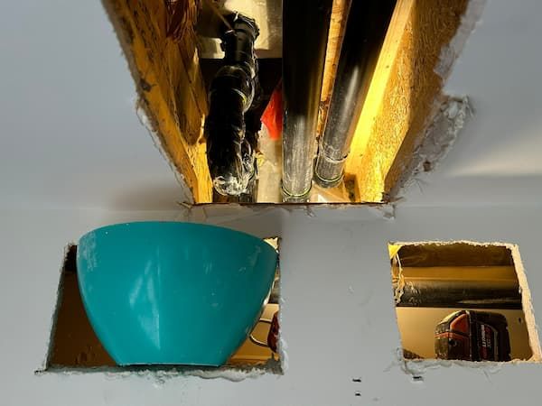 Drywall cut open in Oakville home to investigate hidden bathtub leak.