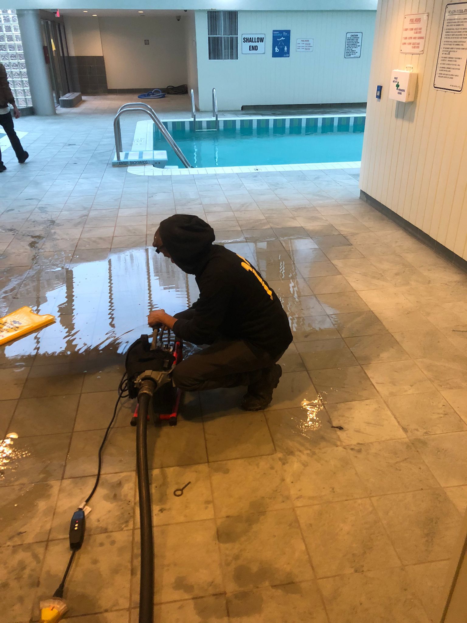 Cable snaking a blocked floor drain in Oakville commercial washroom