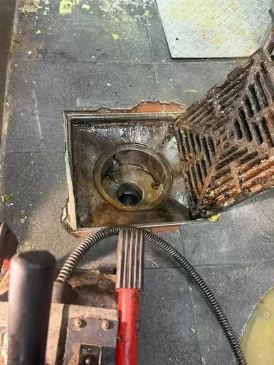drain snaking machine clearing commercial floor drain blockage emergency plumber oakville