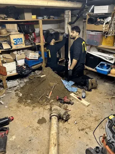 Plumbers replacing damaged sewer line in basement after blockage and flooding requiring emergency plumber oakville to prevent recurring backup