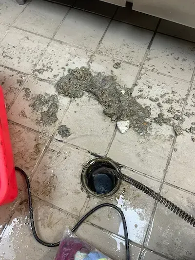 Grease and debris clog removed from commercial floor drain in Oakville kitchen during professional drain cleaning service