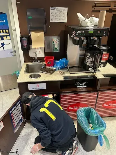 Emergency plumber Oakville clearing commercial kitchen sink drain clog at Tim Hortons