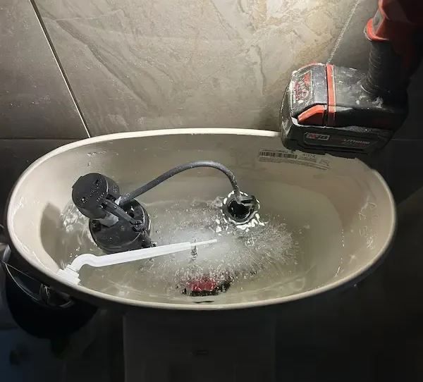 Overflowing toilet tank in Oakville causing active water leak and emergency plumbing issue