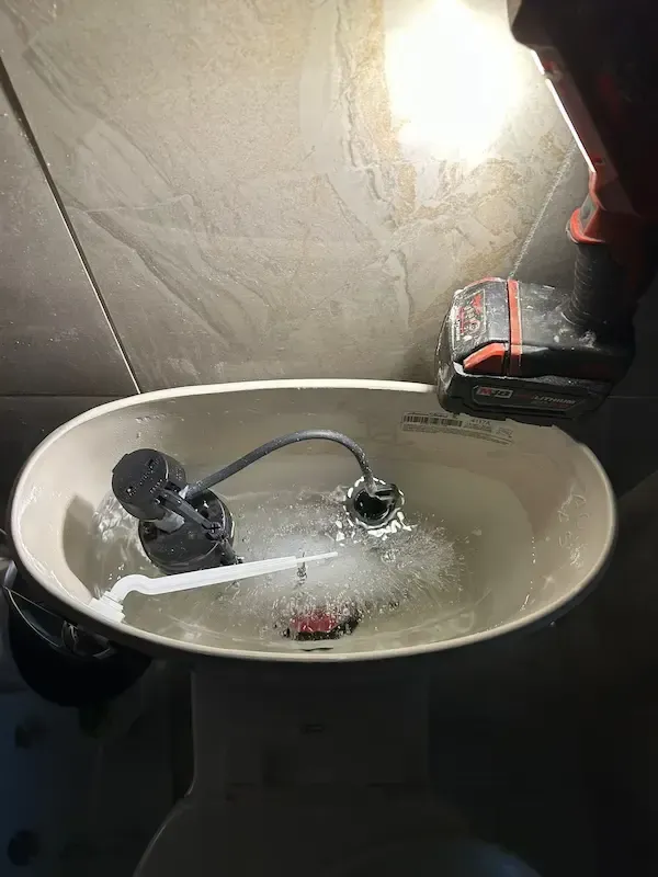 Frozen water inside toilet tank in Oakville during winter plumbing emergency