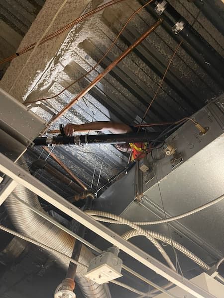 17 Plumbing plumber performing commercial pipe replacement above ceiling .