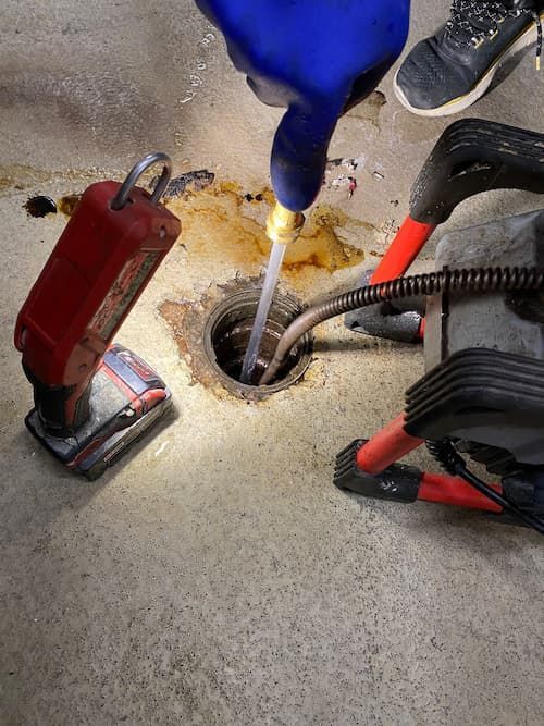Plumber performing hydro-jetting