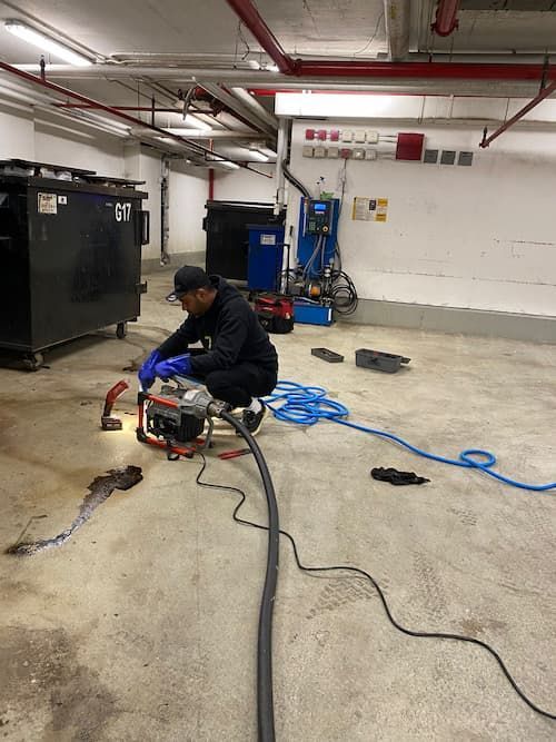 17 Plumbing performing professional powerflushing drain cleaning service in Mississauga commercial facility