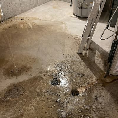 Basement floor drain sewage backup in Oakville requiring emergency drain cleaning service