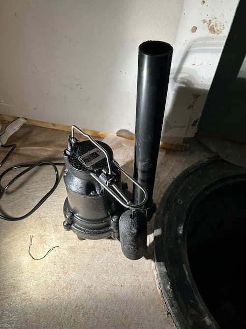New sump pump installation during sump pump replacement in Oakville basement
