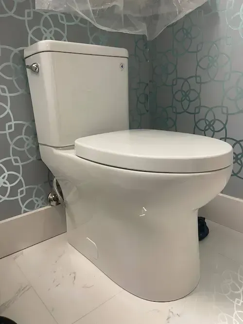 17 Plumbing – Modern toilet installation in bathroom with blue patterned wallpaper in Oakville