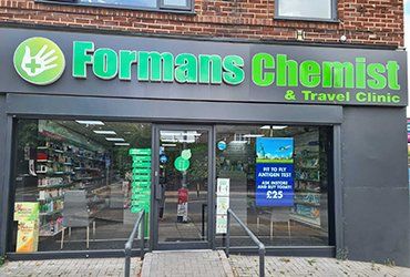 The front of a forman 's chemist and travel clinic