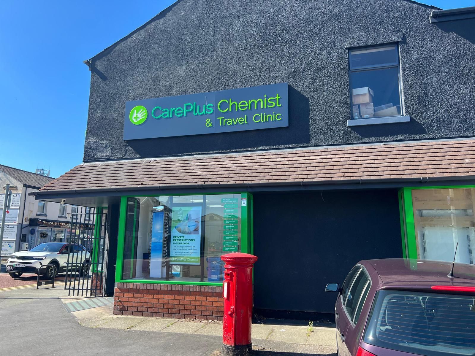 A car is parked in front Careplus pharmacy and travel clinic