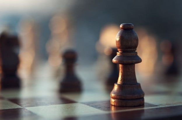 Close Up of a Wooden Chess Piece on a Chess Board — Care FNQ Pty Ltd in Cairns City, QLD