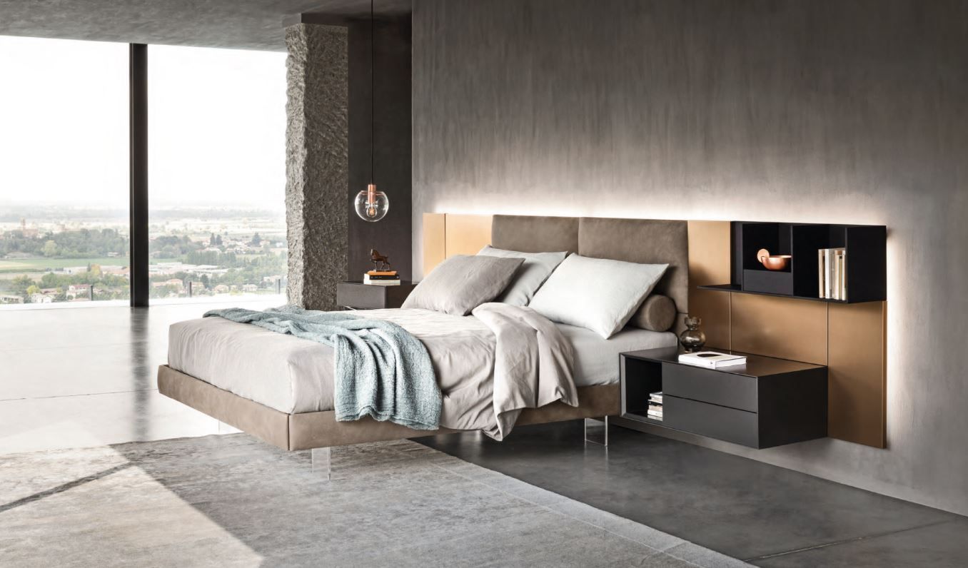 Una camera da letto con un letto, un comodino e una grande finestra.