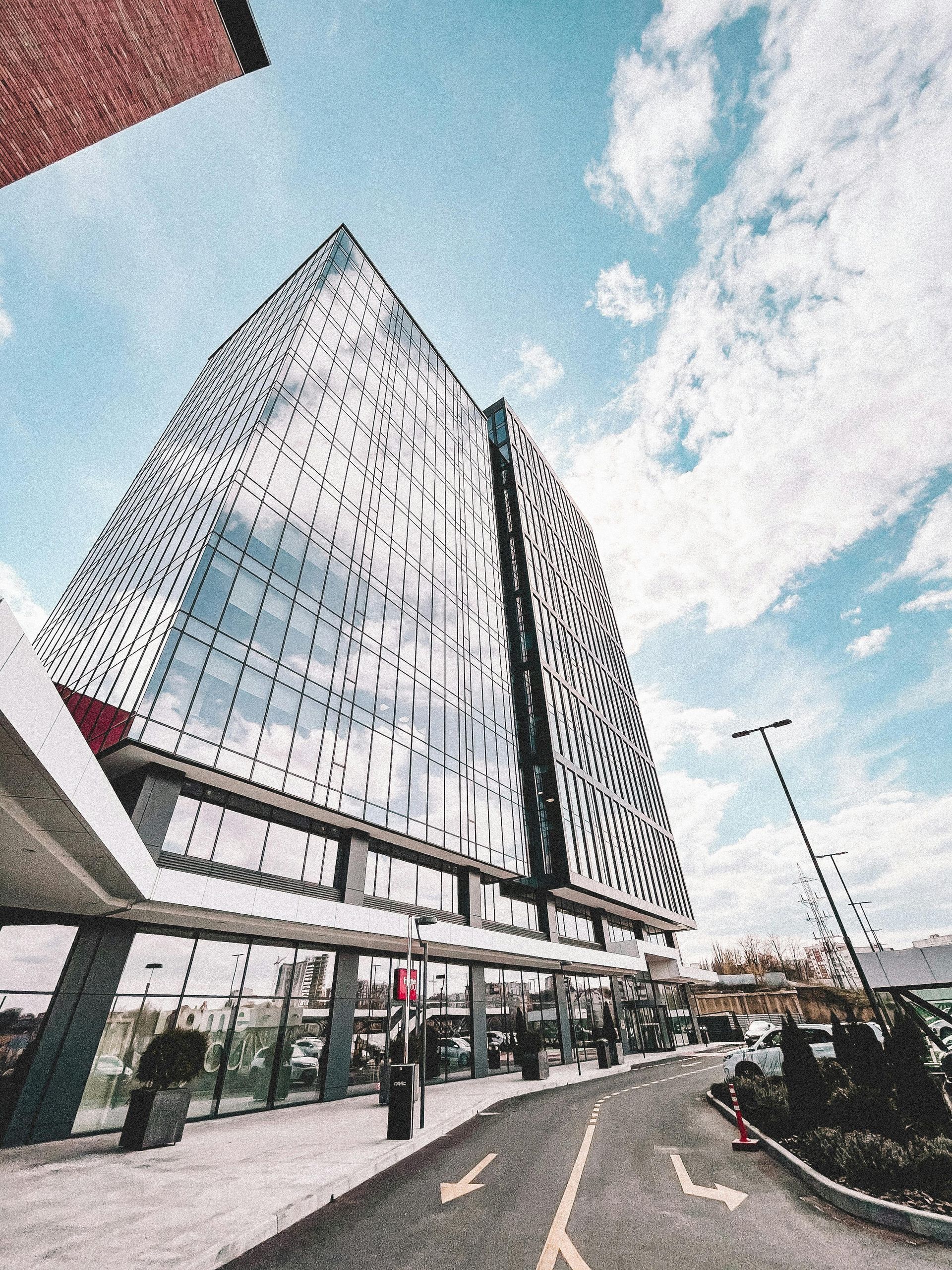 A man is sitting at a table using a calculator and writing on a clipboard.