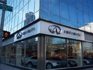 A car dealership with cars parked in front of it.