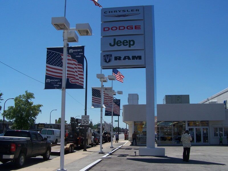 A dodge jeep and ram dealership with cars parked outside