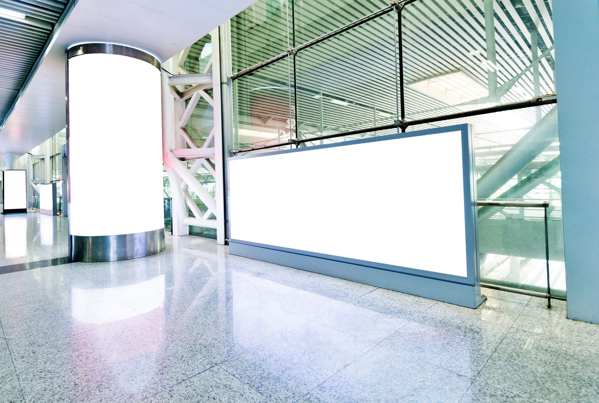 A large white billboard is in the middle of a building