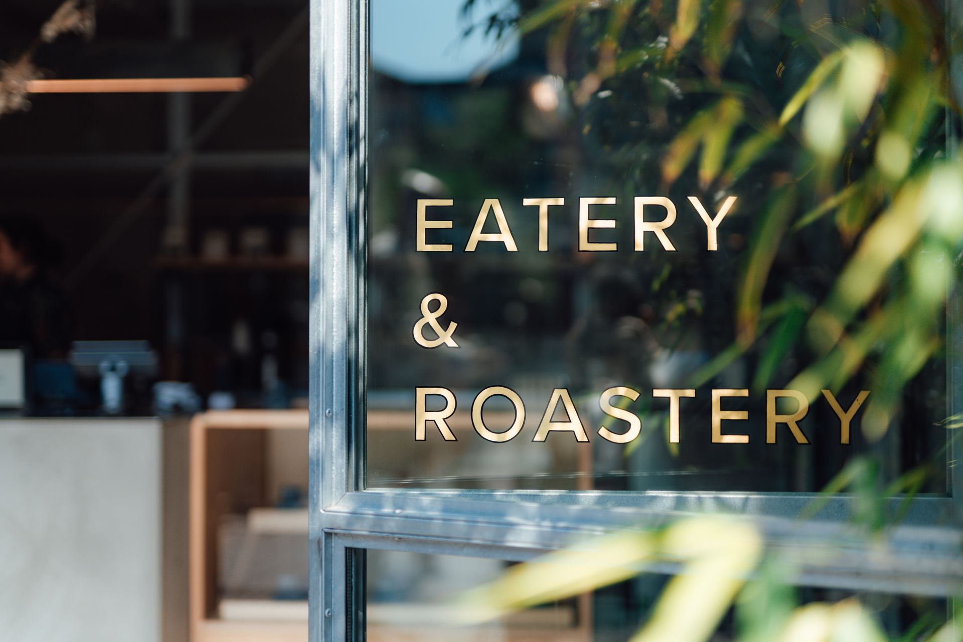 A restaurant with a sign that says eatery and roastery on it.