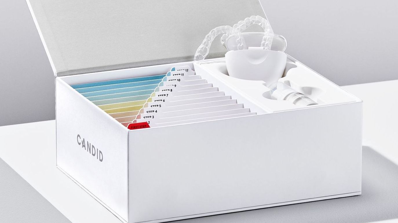 A white box with a tooth whitening kit inside of it.