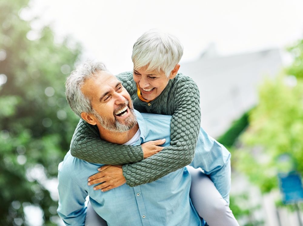 A man is carrying a woman on his back.