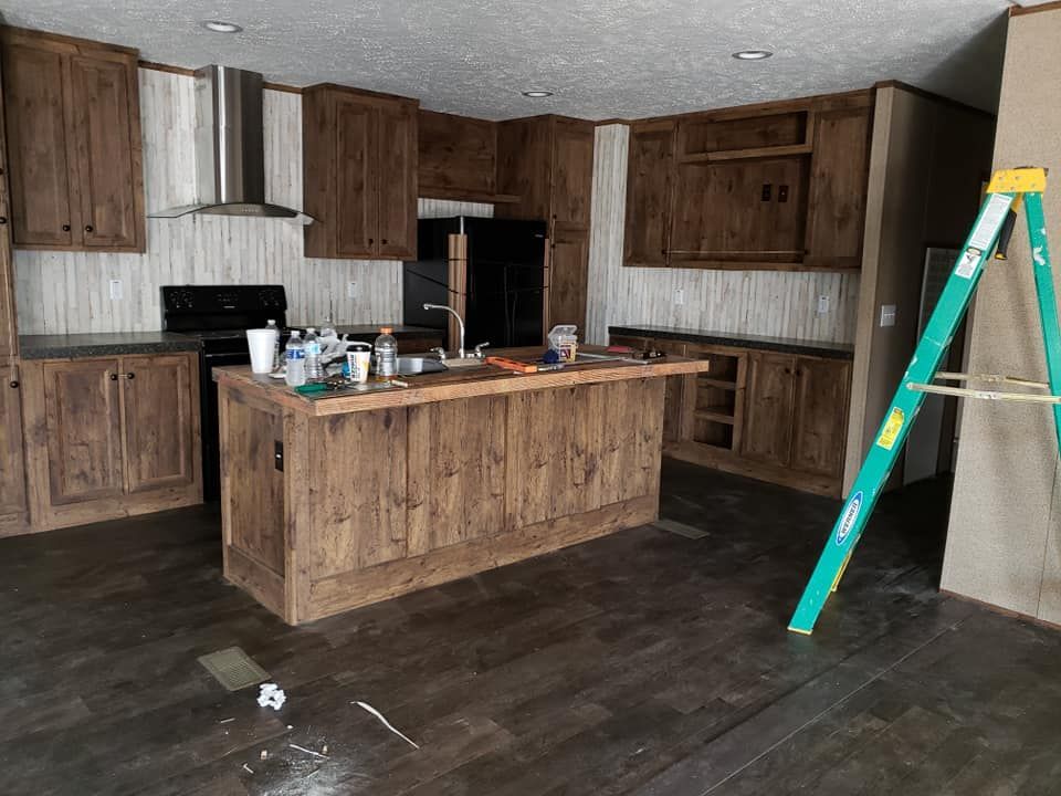 There is a ladder in the middle of the kitchen.