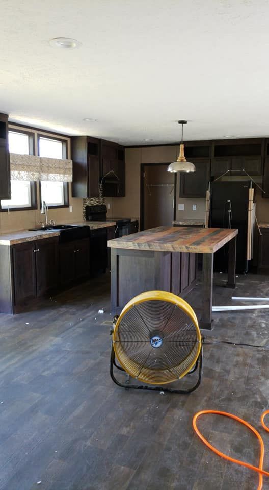There is a fan in the middle of the kitchen.