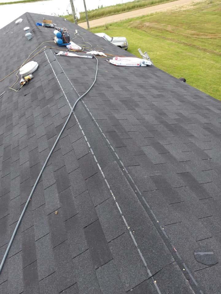 A roof with a rope attached to it is being worked on.