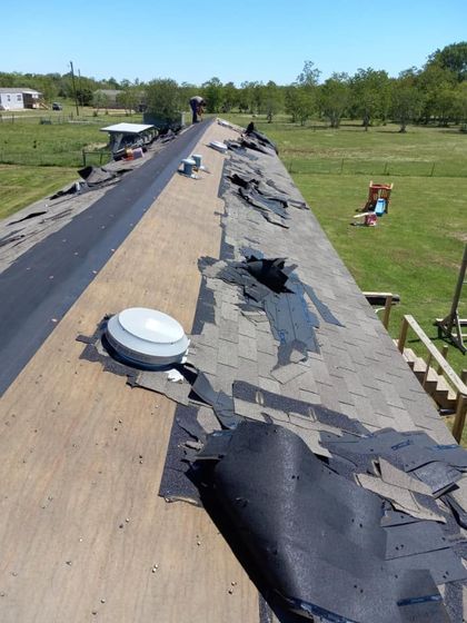 A roof of a house with a lot of shingles on it at night.